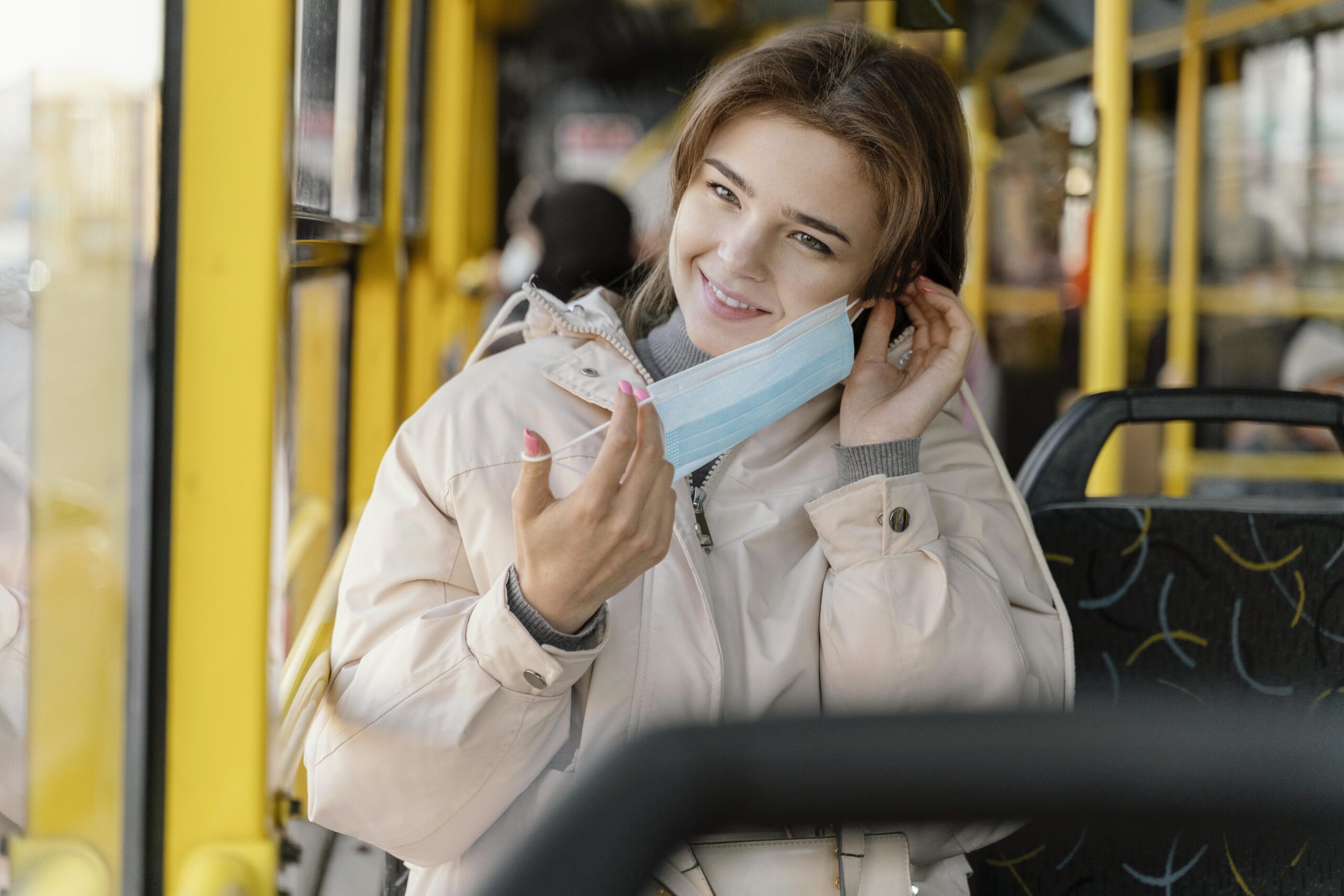 young-woman-travelling-by-city-bus-with-surgical-mask